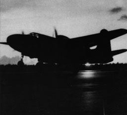 A Douglas P-70 takes off for a night fighter training mission, silhouetted by the setting Florida sun