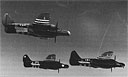 Northrop P-61 Black Widows marked with invasion stripes soar over France