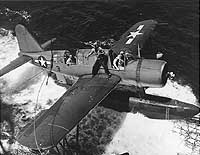 Photo # 80-G-218123: OS2U floatplane is recovered by USS Baltimore after rescuing a pilot from Truk Lagoon, February 1944'
