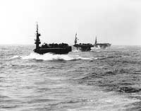 Photo # 80-G-331079:  Escort carriers steam in column through heavy western Pacific seas, March 1945