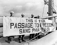 Photo # 80-G-709239:  Banner welcoming Vietnamese refugees aboard USS Bayfield for passage from Haiphong to Saigon, September 1954