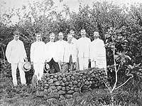 Photo # NH 1900:  Men pay their respects at the grave of Captain Cornelius M. Schoonmaker, who lost his life in the hurricane at Apia, Samoa