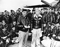 Photo # NH 64472: LtCol James H. Doolittle with Capt. Marc A. Mitscher and Doolittle raid flight crews, on board USS Hornet, April 1942