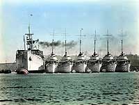 Photo # NH 90545-KN: Color-tinted photo of USS Black Hawk and six destroyers at Chefoo, China, during the 1930s
