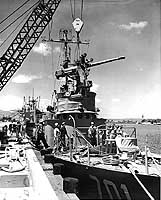 Photo # NH 97002: Korean patrol craft Pak Tu San receiving her main gun, at the Pearl Harbor Naval Shipyard, March 1950.
