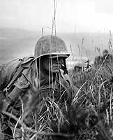 Photo # NH 97032: A Marine inches forward on the central Korean front, 1950-51