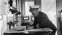Photo # NH 99796:  Commander John H. Boesch in the chart house of USS Orion, circa 1919