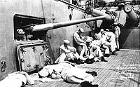 Photo # NH 101111:  Crew members relaxing and reading on board USS Rhode Island, circa 1913.  Photographed by Sargeant