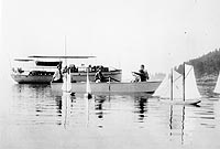 Photo #  NH 101822:  Motor boat Hippocampus, with a rowboat and model sail boats in the foreground, prior to World War I