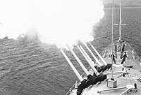 Photo # USN 1113593: USS Galveston fires her 6"/47 guns off Vietnam, 1 August 1965.  Photographed by D.B. Jackson.