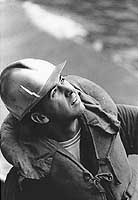 Photo # USN 1121545:  A USS Canberra crewman keeps watch over replenishment operations, March 1967
