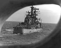 Photo # USN 1166905:  USS Oklahoma City seen through a porthole on USS San Jose, January 1976. Photographed by PH1 J.R. Sheppard, USN.