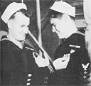 Sailors admiring each other's decorations.