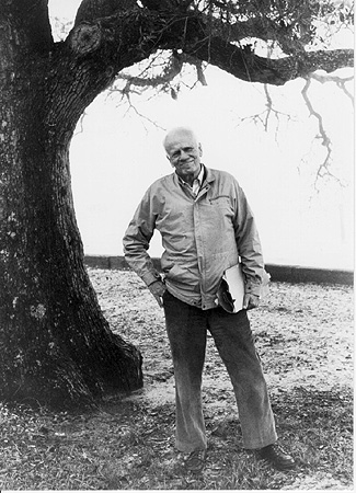 Walker Percy Holding Papers at Oak Tree (Smiling Face)